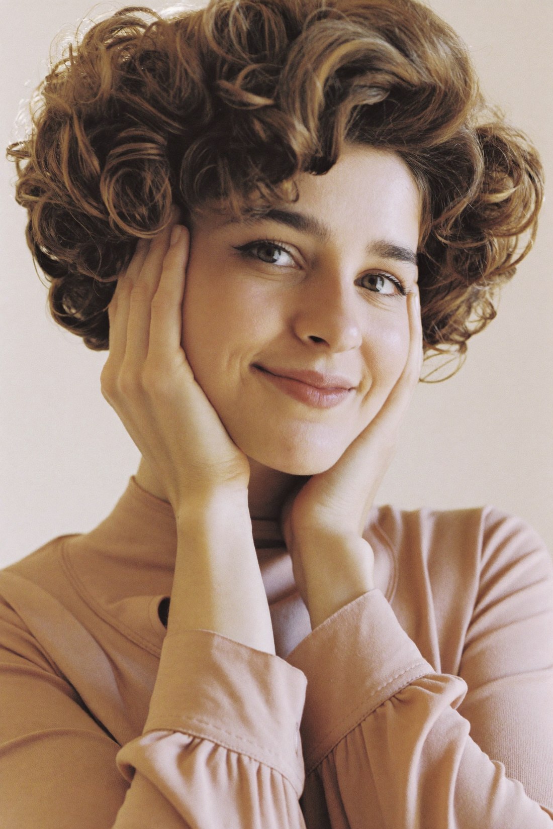A woman in a natural full-coverage Ralph wig